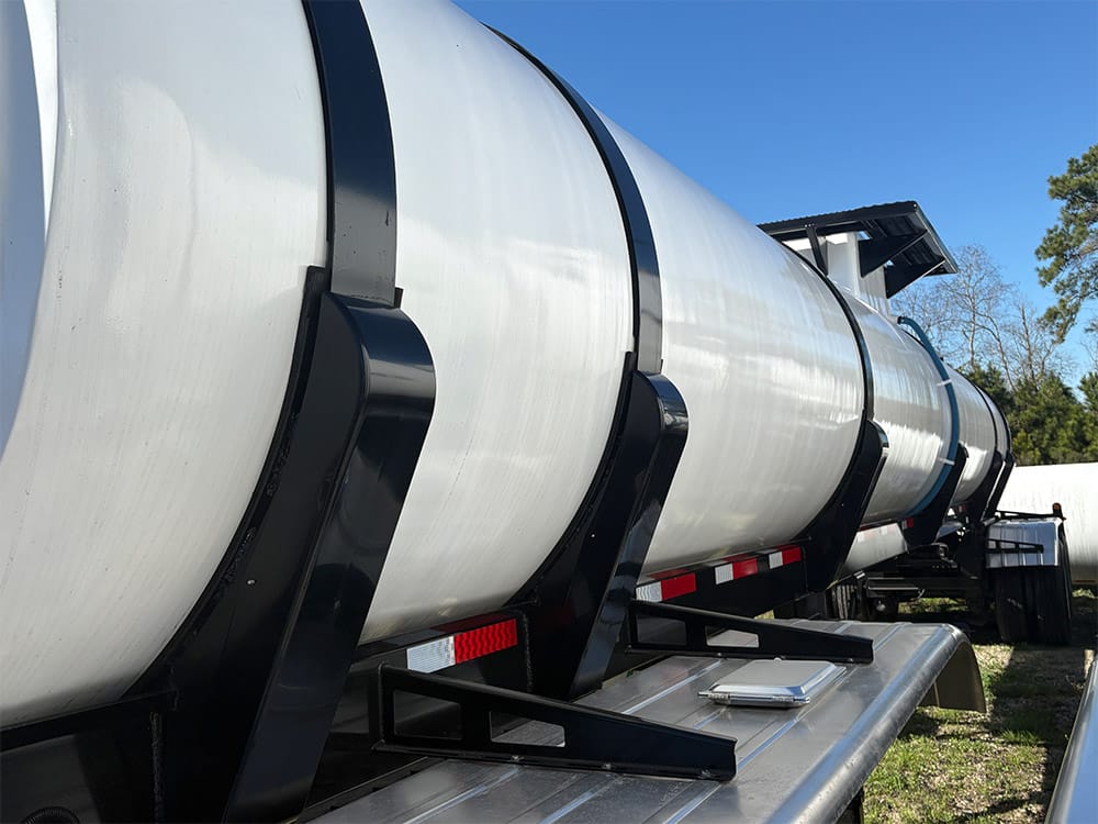 Food-grade tank trailer from Poly-Coat Systems showing the composite tank body and black support bands.