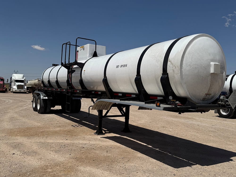 White fiberglass reinforced plastic tank trailer from Poly-Coat Systems shown at a three-quarter angle.