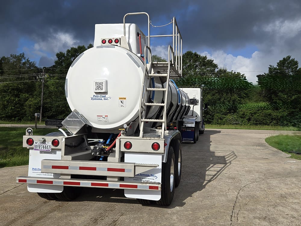 Stock tank trailer from Poly-Coat Systems connected to a truck for delivery.