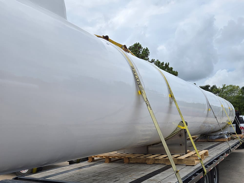 Barrel-only tank from Poly-Coat Systems loaded on a flatbed trailer.